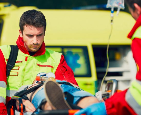 Team of rescuers (paramedic and doctor) preparing the patient after resuscitation for transport to the hospital.